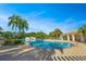 Beautiful community pool featuring mature palms, a sundeck, and convenient access to lounging areas at 8480 Adalina Pl, Orlando, FL 32827