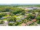 Neighborhood aerial shot featuring mature trees, green lawns and city skyline in the distance at 906 Kensington Dr, Orlando, FL 32808