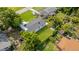 Aerial view of backyard featuring green lawn and surrounding mature trees at 906 Kensington Dr, Orlando, FL 32808