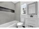 Modern bathroom with gray tile, sleek fixtures, and a bright vanity offering a spa-like experience at 906 Kensington Dr, Orlando, FL 32808