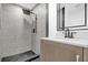Updated bathroom features a walk-in shower with black fixtures and a modern vanity at 906 Kensington Dr, Orlando, FL 32808