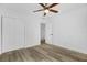 This bright bedroom has a ceiling fan, wood-look flooring, and large closet at 906 Kensington Dr, Orlando, FL 32808