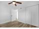 Bedroom featuring a ceiling fan, wood-look flooring and closet with panel doors at 906 Kensington Dr, Orlando, FL 32808