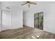 Bedroom featuring wood-look floors, a ceiling fan, and sliding glass doors to the backyard at 906 Kensington Dr, Orlando, FL 32808