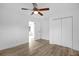 Comfortable bedroom with wood flooring, ceiling fan, and double closets providing ample storage at 906 Kensington Dr, Orlando, FL 32808