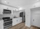 Modern kitchen with white cabinets, stainless steel appliances, and subway tile backsplash at 906 Kensington Dr, Orlando, FL 32808