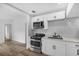 Well-lit kitchen with stainless steel appliances, white cabinetry, and stylish subway tile backsplash at 906 Kensington Dr, Orlando, FL 32808