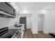 Updated kitchen featuring white cabinets, stainless steel appliances, and modern fixtures at 906 Kensington Dr, Orlando, FL 32808