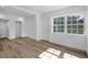 Sunlit living area with new flooring and white trim; showcases a bright, airy atmosphere at 906 Kensington Dr, Orlando, FL 32808
