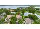 Expansive lakefront property with a home featuring a tile roof, pool, and lush landscaping at 9138 Great Heron Cir, Orlando, FL 32836