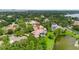 Aerial view of a stunning home with a private pool, nestled within lush, green surroundings near a lake at 9138 Great Heron Cir, Orlando, FL 32836