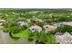 Aerial view of a sprawling lakeside property with a large home, pool, and lush landscaping at 9138 Great Heron Cir, Orlando, FL 32836