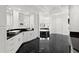 Sleek bathroom boasts black marble floors, dual sinks, soaking tub, and white custom cabinets at 9138 Great Heron Cir, Orlando, FL 32836