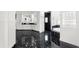Modern bathroom with black marble floors, soaking tub, and glass block shower at 9138 Great Heron Cir, Orlando, FL 32836
