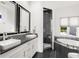 Modern bathroom with dual sinks, sleek black and white design, glass enclosed shower, and soaking tub at 9138 Great Heron Cir, Orlando, FL 32836