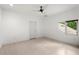 Clean, bright bedroom features wood flooring, a ceiling fan, and a window with treetop views at 9138 Great Heron Cir, Orlando, FL 32836