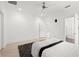 Modern bedroom features wood floors, a ceiling fan, white walls, and bright natural light at 9138 Great Heron Cir, Orlando, FL 32836