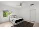 Modern bedroom featuring wood floors, ceiling fan, and a cozy bed with pillows at 9138 Great Heron Cir, Orlando, FL 32836