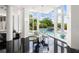 Modern dining area with glass table, chairs, black tile floors, and pool view at 9138 Great Heron Cir, Orlando, FL 32836