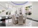 Bright dining area with marble floors, glass table, spiral staircase, and an adjacent outdoor pool at 9138 Great Heron Cir, Orlando, FL 32836