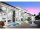 Dramatic twilight accentuates this home's modern design, featuring an inviting pool and grand windows at 9138 Great Heron Cir, Orlando, FL 32836