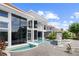 A modern estate boasts a unique pool feature under clear skies, complemented by sleek architecture at 9138 Great Heron Cir, Orlando, FL 32836