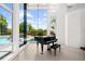 Elegant foyer with piano and floor-to-ceiling windows overlooking the outdoor pool area at 9138 Great Heron Cir, Orlando, FL 32836