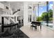 Elegant foyer with black tile floor, grand staircase, and floor-to-ceiling windows overlooking the pool at 9138 Great Heron Cir, Orlando, FL 32836
