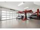 Spacious garage with vehicle lift, frosted glass door, epoxy floor, and ample space for parking and storage at 9138 Great Heron Cir, Orlando, FL 32836