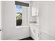 Hallway area featuring modern cabinetry, a sink, and a bright window that offers views of the outdoors at 9138 Great Heron Cir, Orlando, FL 32836