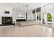 Spacious living room with a fireplace, projector, and floor-to-ceiling windows at 9138 Great Heron Cir, Orlando, FL 32836