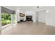 Bright open-concept living area with a stone fireplace and large windows overlooking the outdoors at 9138 Great Heron Cir, Orlando, FL 32836