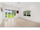 Bright living room featuring white walls, light wood floors, and floor to ceiling glass door to the outdoor space at 9138 Great Heron Cir, Orlando, FL 32836