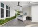 Outdoor kitchen with bar seating, stainless steel grill, and white-stone accent wall at 9138 Great Heron Cir, Orlando, FL 32836