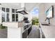 Gourmet outdoor kitchen with grill, stainless hood vent and sink, and bar seating at 9138 Great Heron Cir, Orlando, FL 32836