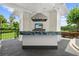 Outdoor kitchen with blue countertop, stainless steel appliances, and stone backsplash at 9138 Great Heron Cir, Orlando, FL 32836