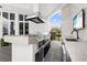 Outdoor kitchen featuring stainless grill, hood vent, and adjacent sink at 9138 Great Heron Cir, Orlando, FL 32836