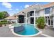 Stunning home showcasing a pool wrapping around its elegant exterior, enhanced by pillars and spa at 9138 Great Heron Cir, Orlando, FL 32836