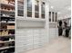 Spacious walk-in closet with custom shelving, drawers, and ample storage space at 9138 Great Heron Cir, Orlando, FL 32836