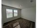Cozy bedroom featuring plush carpeting, two windows with horizontal blinds, and fresh, neutral paint at 930 Cattleman St, Winter Haven, FL 33881