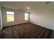Inviting carpeted bedroom with natural light streaming through two windows at 930 Cattleman St, Winter Haven, FL 33881