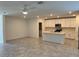 Open-concept kitchen with modern white cabinets, a central island, and stainless steel appliances at 930 Cattleman St, Winter Haven, FL 33881