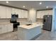 Modern kitchen featuring white cabinetry, stainless steel appliances, and a large island at 930 Cattleman St, Winter Haven, FL 33881