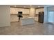 Well-lit kitchen with white cabinets, stainless steel appliances, and a large central island at 930 Cattleman St, Winter Haven, FL 33881