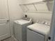 Bright laundry room equipped with a modern washer and dryer and shelving at 930 Cattleman St, Winter Haven, FL 33881