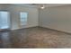 Bright living room with tiled floor and large windows and a door to a patio at 930 Cattleman St, Winter Haven, FL 33881