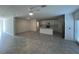 Open-concept living space leading to kitchen with stainless appliances and center island at 930 Cattleman St, Winter Haven, FL 33881