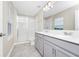 Bright bathroom with double vanity, frameless shower, and modern fixtures at 9909 Alliteration Aly, Winter Garden, FL 34787