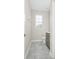 Compact bathroom with gray vanity, toilet, and natural light from the window at 9909 Alliteration Aly, Winter Garden, FL 34787