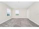 Large, carpeted bedroom with bright light from two windows and a closet at 9909 Alliteration Aly, Winter Garden, FL 34787